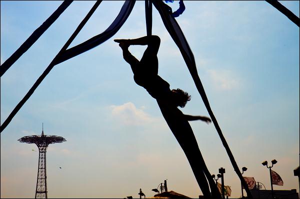 House of Yes silk aerialists perform on the Coney Island boardwalk following the 2010 Mermaid Parade.