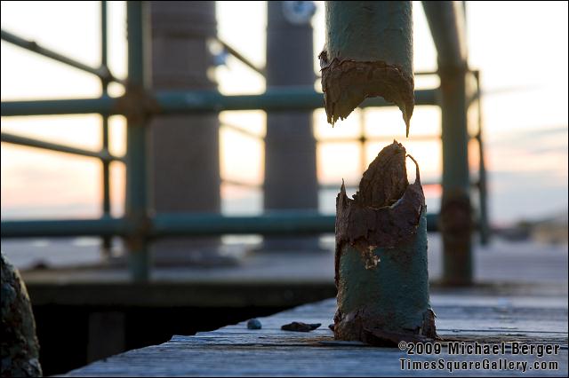 Rusted weather worn post on the Riis Park boardwalk at sunset. 2008.